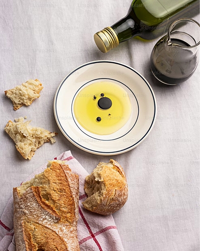 A picture of olive oil with some bread